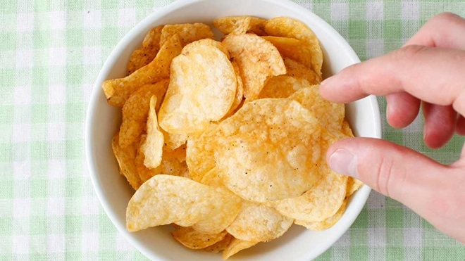 hand over bowl of chips shrinking pack sizes lead
